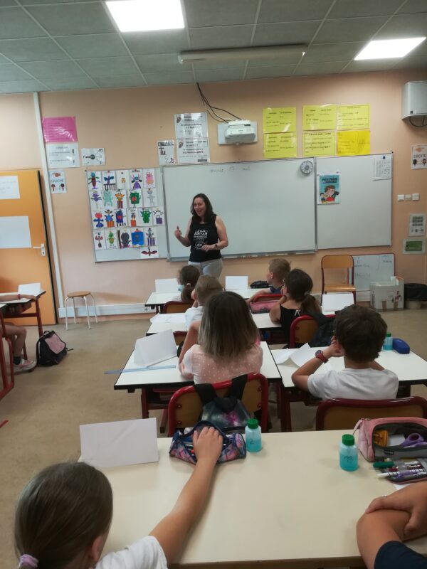 Nathalie dans la salle de classe avec les élèves de dos