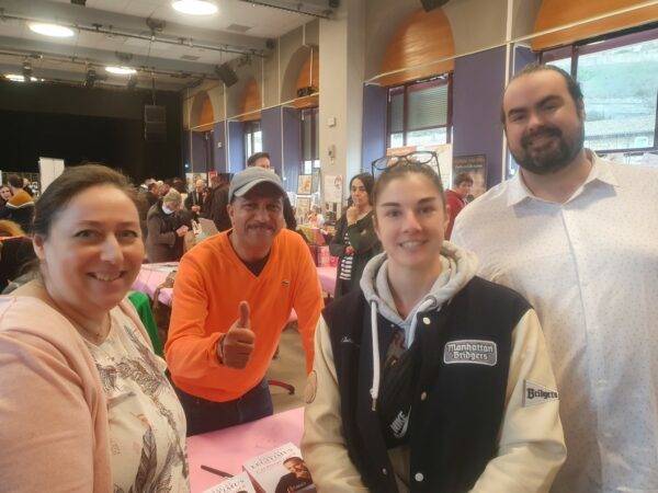 Photo de Nathalie, Jérémy, l'une de ses bénévoles et Pascal Légitimus sur le stand de Pascal
